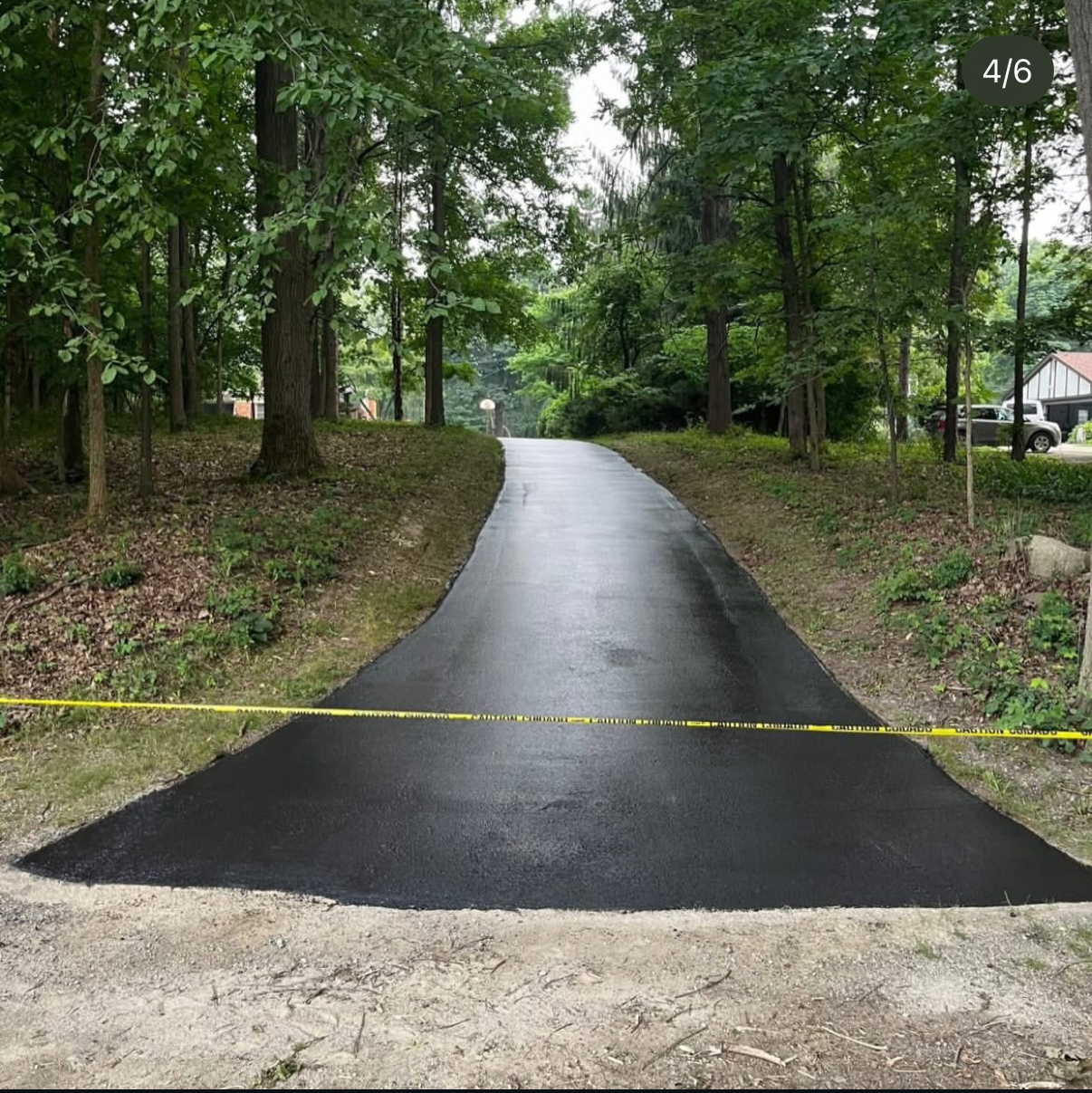 Freshly sealcoated wooded driveway